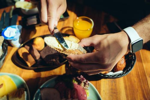 a person is cutting into a sandwich on a table at ONOMO Hotel Casablanca City Center in Casablanca