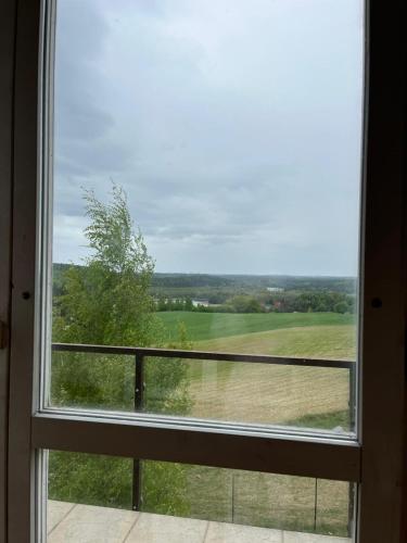 a window with a view of a golf course at Dom Na Wichrowym Wzgórzu in Brodnica