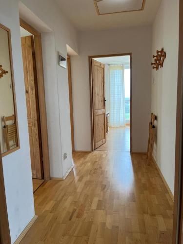 an empty room with a wooden floor and doors at Dom Na Wichrowym Wzgórzu in Brodnica