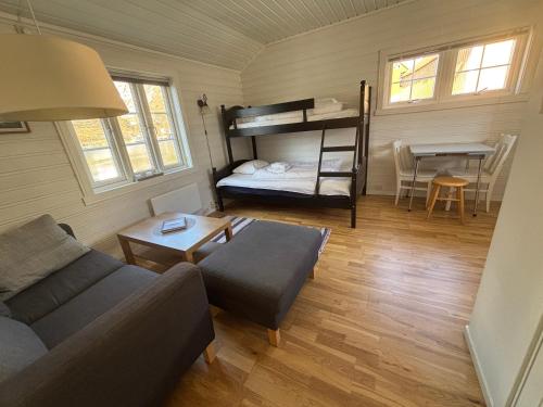 a living room with a couch and a bunk bed at Reinebua in Reine