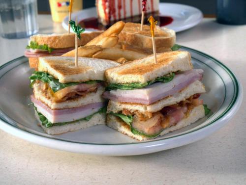 a plate with a cut in half sandwich and french fries at The Portlander Inn and Marketplace in Portland