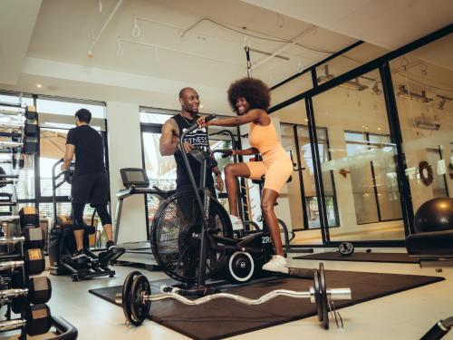 a man and a woman on a bike in a gym at ONOMO Hotel Casablanca City Center in Casablanca