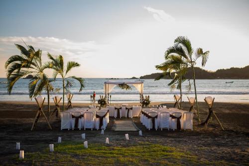 a wedding on the beach with tables and chairs at Qualton Club Ixtapa All Inclusive in Ixtapa