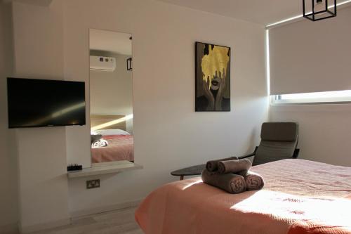 Ένα ή περισσότερα κρεβάτια σε δωμάτιο στο Nicosia Central Suites