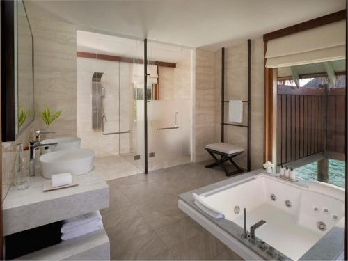 a large bathroom with a tub and a shower at Conrad Maldives Rangali Island in Mandhoo