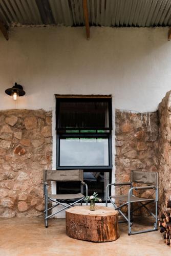 a room with a table and two chairs and a window at Zwakala River Retreat in Haenertsburg