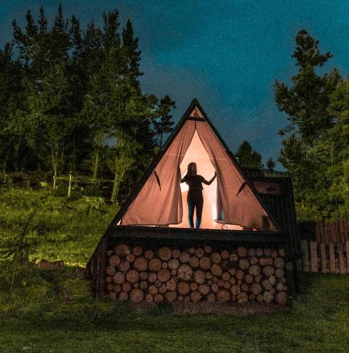 a person standing inside of a tent at La Quinta Glamping - Lago de Tota in Cuítiva