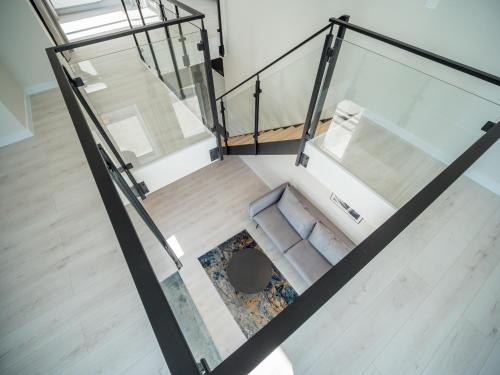 an overhead view of a staircase with glass railing at Art Boulevard in Mrzeżyno