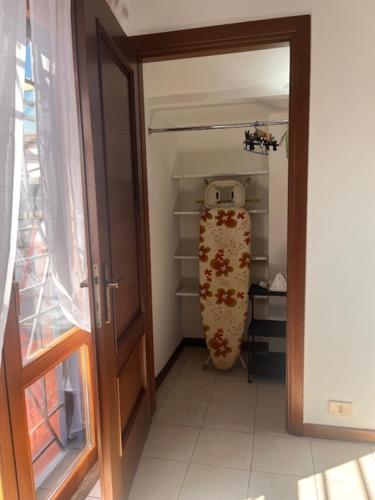 a door to a closet with a snowboard in it at Il Cavalluccio Marino in Ladispoli