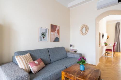 a living room with a couch and a table at Vienna Stay Apartments Schönbrunn in Vienna