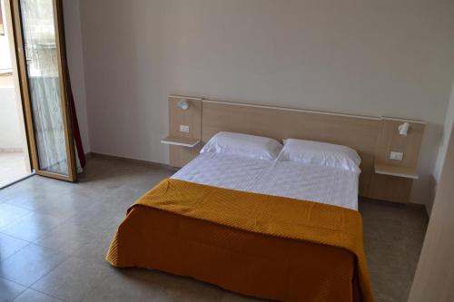 Un pat sau paturi într-o cameră la B&B Coppularossa