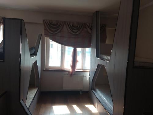 an empty room with a window and a curtain at Guest House Ulaanbaatar in Ulaanbaatar