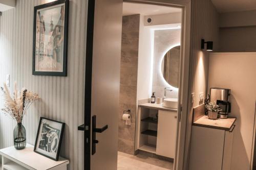 une salle de bain avec un lavabo et un miroir dans l'établissement Studio Le Benetin 2 personnes à Dinan, à Dinan