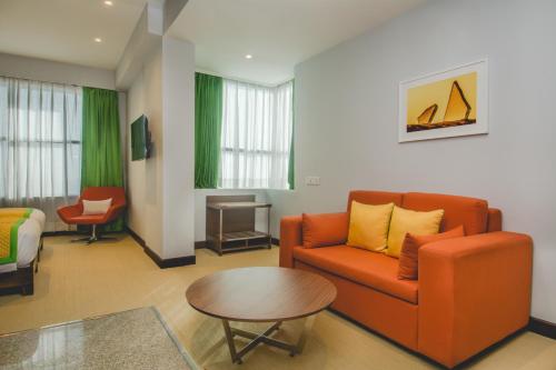 a living room with a couch and a table at Vega By The Ozone Hotels in Jodhpur