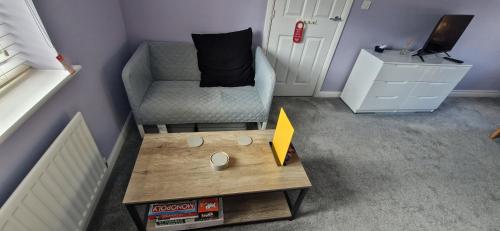 a small living room with a chair and a table at Double B&B Room in Southwater with Private Bathroom and Parking in Southwater