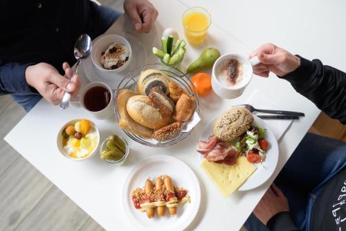 a table full of food on a white table at ibis budget Hamburg St Pauli Messe - neu renoviert in Hamburg