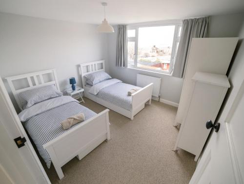 a bedroom with two beds and a window at No 26 The perfect Brighton Getaway in Brighton & Hove