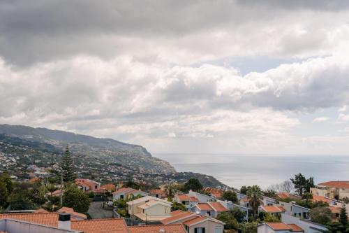 a view of a city with houses and the ocean at Ponta do Sol Amazing 3 Bedroom Apartment in Ponta do Sol