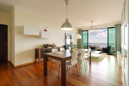 a kitchen and dining room with a table and chairs at Ponta do Sol Amazing 3 Bedroom Apartment in Ponta do Sol