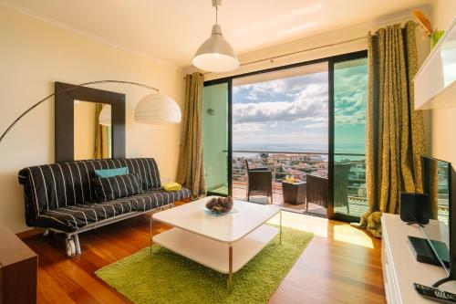 a living room with a couch and a table at Ponta do Sol Amazing 3 Bedroom Apartment in Ponta do Sol