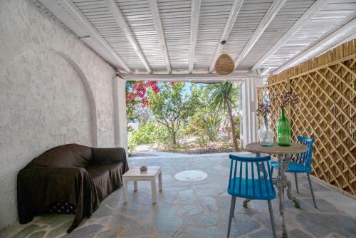 a living room with a couch and a table and chairs at Maggano Paros Apartments 3 in Angairiá