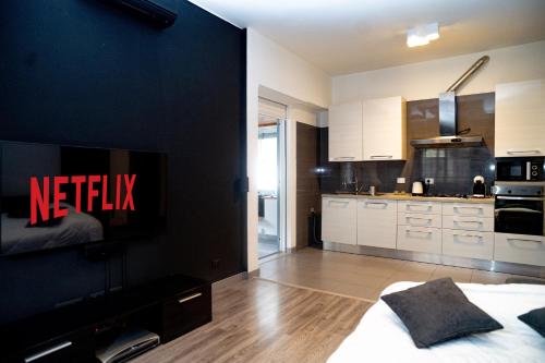 a bedroom with a bed and a tv on a wall at LED, comfort and style just a few minutes from the Colosseum in Rome