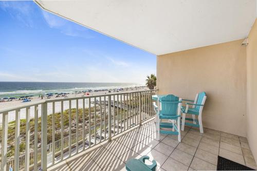 a balcony with chairs and a view of the beach at Four Winds 301 in Orange Beach