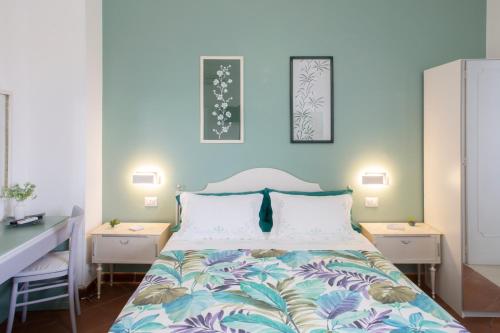 a bedroom with a bed with two night stands and two tables at Domus Liventa B&B in Cursi