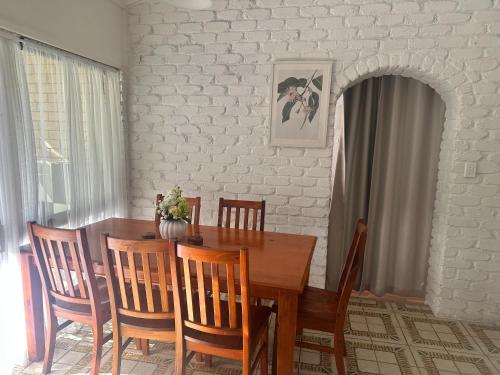 a dining room with a wooden table and chairs at Luxurious and Stylish House in Browns Plains