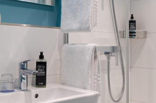 a bathroom sink with a bottle of soap on it at ibis budget Hamburg St Pauli Messe - neu renoviert in Hamburg