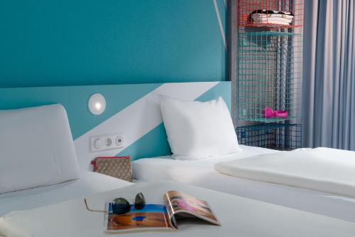 a hotel room with a bed with a pair of shoes on it at ibis budget Hamburg St Pauli Messe - neu renoviert in Hamburg