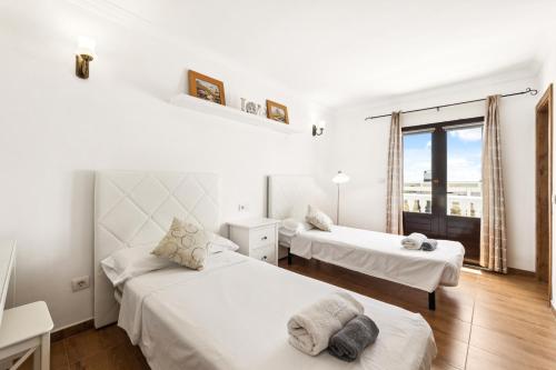 zwei Betten in einem Zimmer mit Fenster in der Unterkunft Villa dona Isidora - VipVipVillas in Teguise