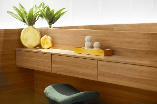 a wooden shelf with a chair and vases on it at Stavros Beachfront Suites in Nea Kydonia