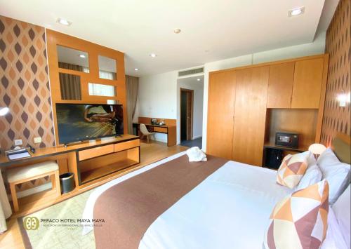 Una cama o camas en una habitación de Pefaco Hotel Maya Maya