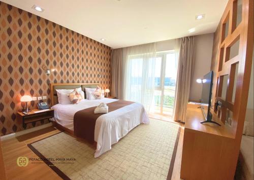 Postel nebo postele na pokoji v ubytování Pefaco Hotel Maya Maya