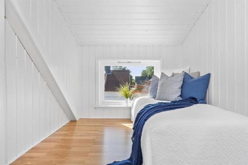 Una habitación blanca con dos camas y una ventana. en Higly rated superhost in citycenter, en Tønsberg