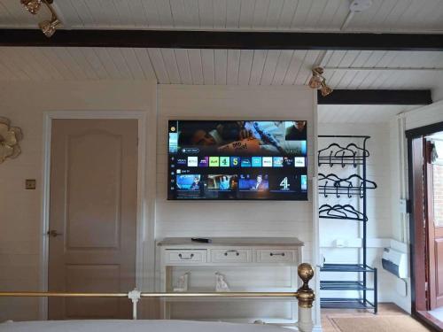 a living room with a tv on the wall at 1 Bed Lodge - Southampton - Sleeps 2 - Parking in Southampton