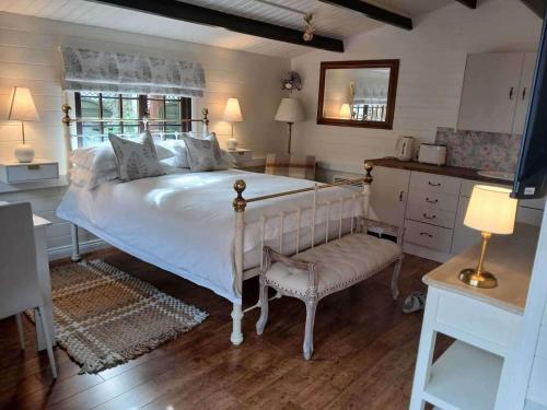 a bedroom with a large white bed and a chair at 1 Bed Lodge - Southampton - Sleeps 2 - Parking in Southampton
