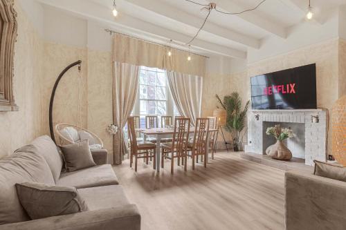 a living room with a couch and a table and chairs at Quirky & Wonky Inn - 4 BD in Brighton & Hove