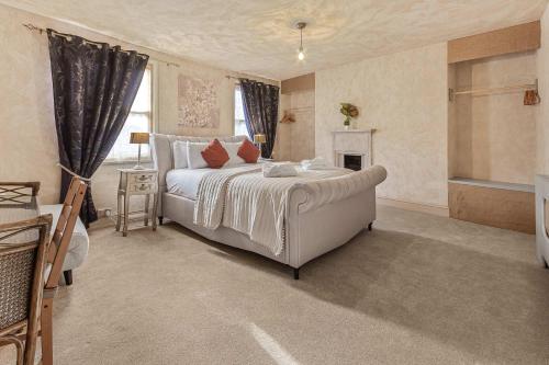 a bedroom with a large bed and a fireplace at Quirky & Wonky Inn - 4 BD in Brighton & Hove