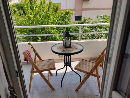 a table and two chairs on a balcony at MiNa Apartments in Petrovac na Moru