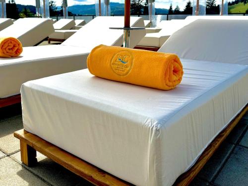 a yellow towel is sitting on top of a bed at Domeniul CRIS Vatra Dornei in Vatra Dornei