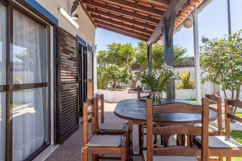 an outdoor dining area with a table and chairs on a patio at Nest by the Lagoa, Carvalhal in Grândola