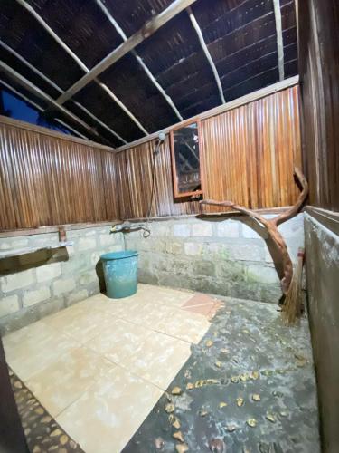 an empty room with a tree branch on the floor at Fam Homestay in Fam