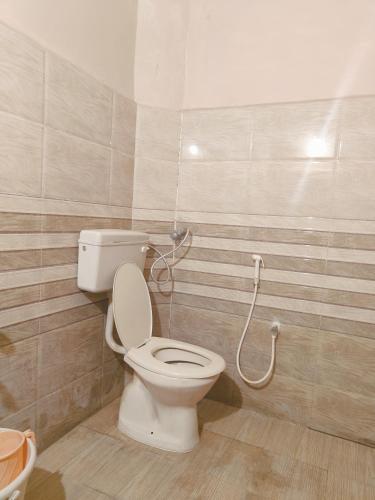 a bathroom with a toilet and a shower at MLC Stays in Tirupati