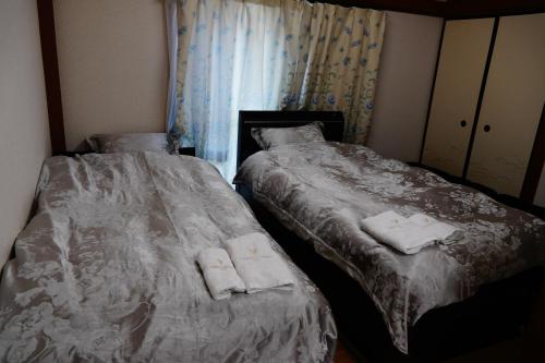 Cama o camas de una habitación en MINPAKU-P 民泊p
