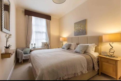 a bedroom with a large bed and a window at London Guest Room in London