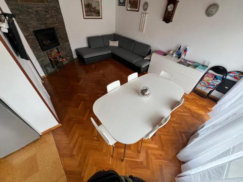 a living room with a white table and a couch at Apartma Magnolija in Nova Gorica