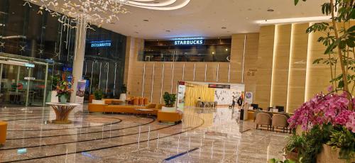 a lobby of a shopping mall with tables and chairs at Sunway Geo Suites at Bandar Sunway by Ezprop-CA0F in Subang Jaya