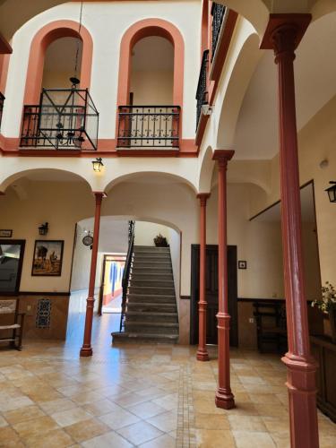 a building with a staircase with red columns at Jayca in Trujillo